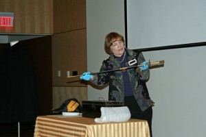 Collections Manager Wanda Edwards with a pre-WW2, sharkskin-handled sword.